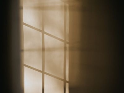Abstract patterns of light and shadow on a wall.